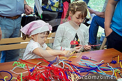 Small girls participating at art and craft outdoor workshop Editorial Stock Photo